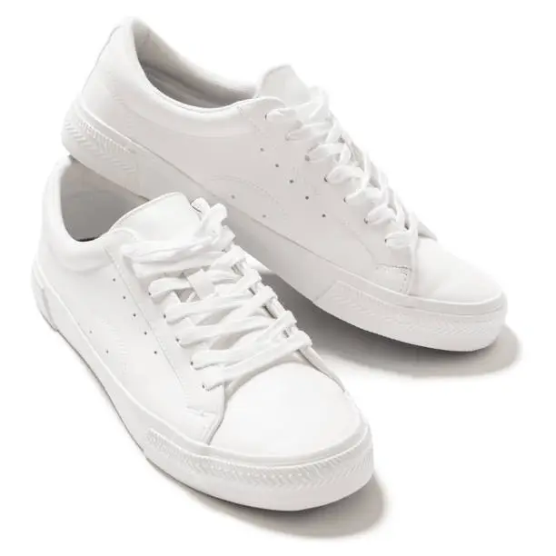 Photo of Pair of white leather trainers on white background