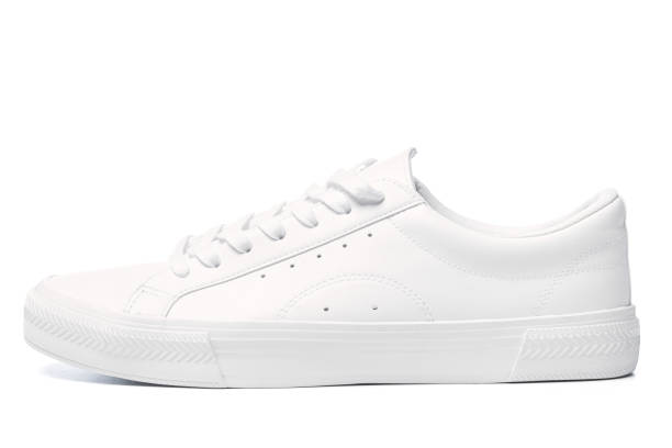 istock Pair of white leather trainers on white background 1324847250