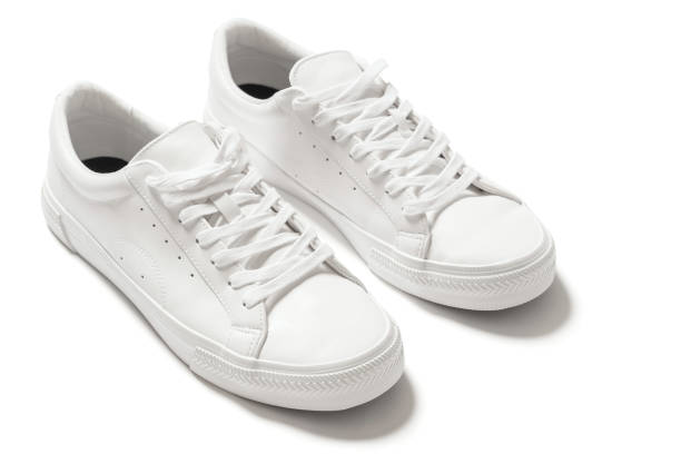 istock Pair of white leather trainers on white background 1324847260