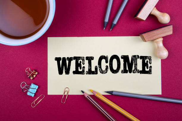 Welcome. Sheet of paper and office supplies on a red table Welcome. Sheet of paper and office supplies on a red table. guest photos stock pictures, royalty-free photos & images
