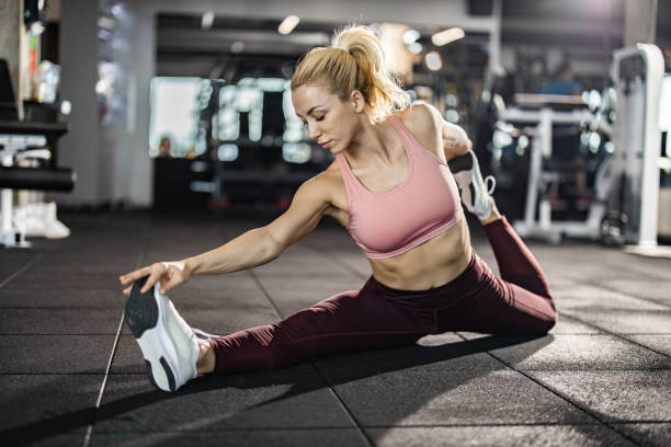 istock Athletic woman stretching her legs in a gym. 1324848666