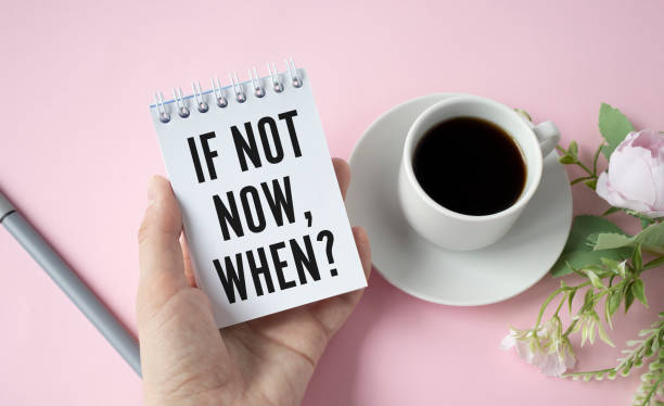 istock If Not Now, When, Businessman holding a card with a message text written on it 1324851918