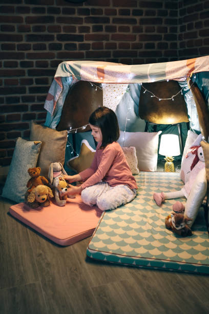 istock Girl playing with stuffed animals in a teepee 1324852209