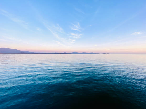 Horizontal seascape of the view from Port Douglas, far north Queensland, across the Coral Sea  to the distant Mossman Ranges and the Daintree National Park on the far horizon
