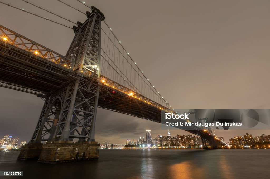 View of the Brooklyn, Manhattan and Williamsburg Bridge at night. Long Exposure Photo Shoot. The Williamsburg Bridge is a suspension bridge in New York City across the East River connecting the Lower East Side of Manhattan at Delancey Street with the Williamsburg neighborhood of Brooklyn Williamsburg Bridge Stock Photo