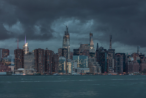 NYC Cityscape with Stormy Cloudy Blue Sky in Background. Late Autumn Skyline