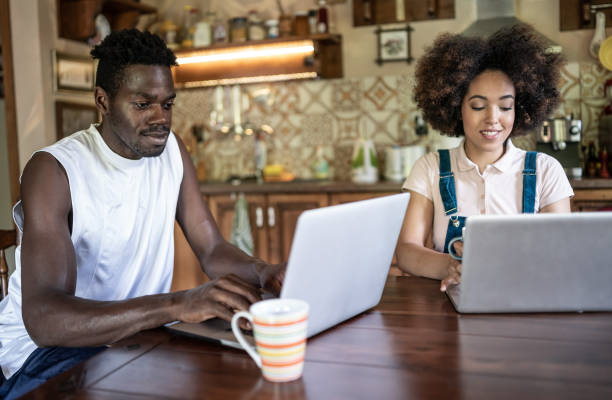 istock Afro couple working from home in the kitchen and having breakfast together, during COVID-19 1324856408