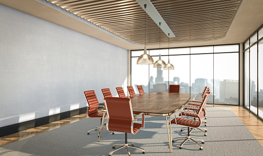 An interior of a boardroom table surounded by burgundy colored chairs in a loft office in the daylight - 3D render