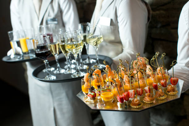 istock Canapes and wine on tray in waitor's hand 1324857476