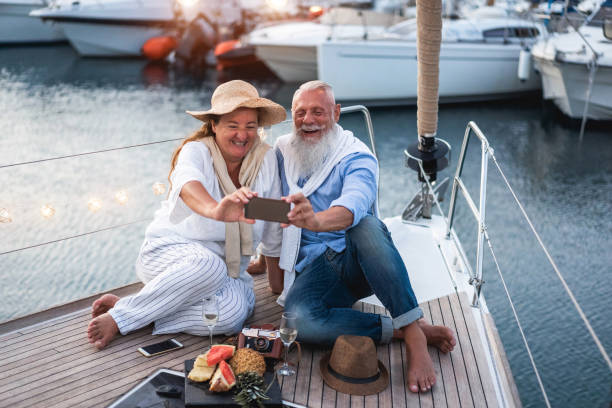 istock Senior couple having fun doing selfie on sailboat during summer vacation - Main focus on senior man face 1324857768