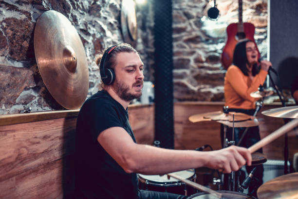 istock Bearded Drummer Focused On Song Recording Process In Studio His Band 1324859812
