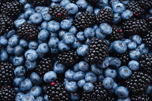 istock Blackberry and  blueberry background. Top view. 1324861429