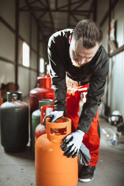 istock Bearded Worker Ready To Haul Heavy Gas Cylinder For Refilling 1324862432