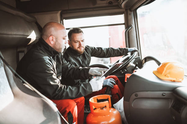istock Tanker Truck Crew Discussing New Route Before Setting Out For Trip 1324862551