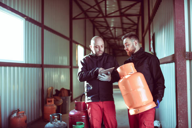 istock Liquified Gas Storage Workers Setting Up Refilling Schedules For Different Cylinders On Digital Tablet 1324862634