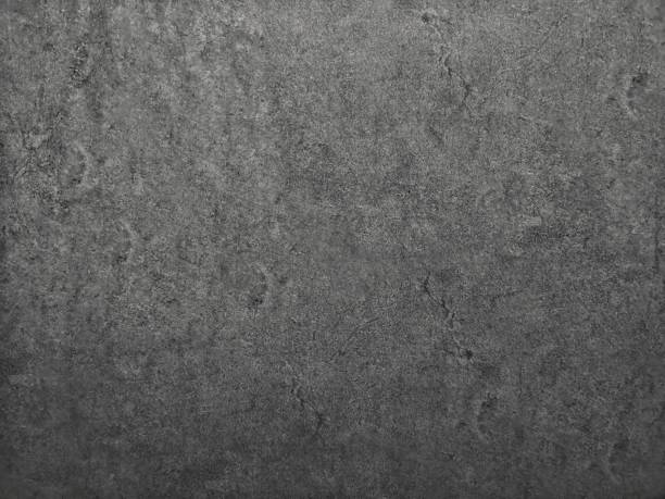 istock black​ color​ paint​ on Cement​ wall​ concrete textured background​ abstract​ dark​ grey​ color​ material​ smooth surface 1324862950