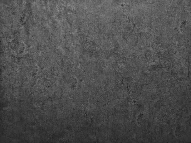 istock black​ color​ paint​ on Cement​ wall​ concrete textured background​ abstract​ dark​ grey​ color​ material​ smooth surface 1324862964