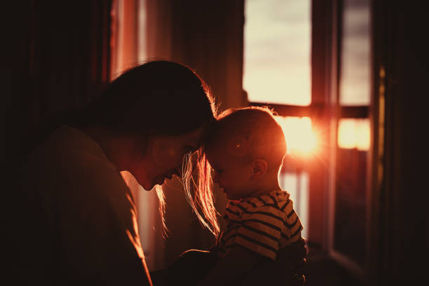 Happy Mom and newborn child enjoying winter holidays