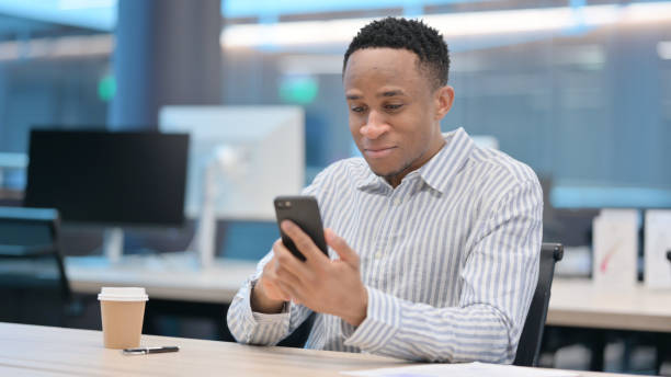 istock African Businessman Browsing Internet on Smartphone 1324865199