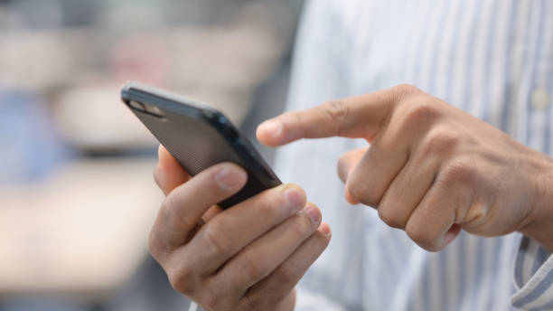 istock Close up of African Man using Smartphone 1324865579