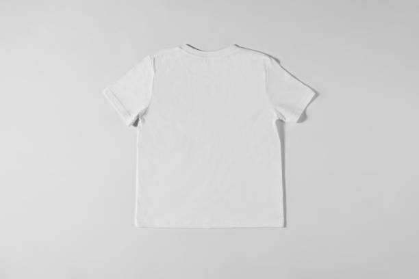 istock White T-shirt lying on a light background 1324865611