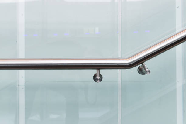 istock Metal handrail with fasteners on the protective glass panel. 1324865703
