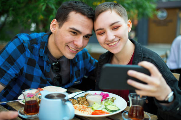 istock Young couple making selfie/video call in a cafe 1324866511