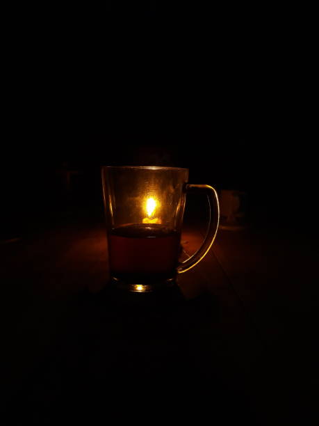 istock Candle behind a cup of coffee 1324866921