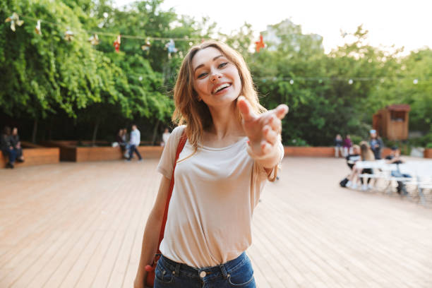 istock Smiling young woman with backpack standing 1324866968