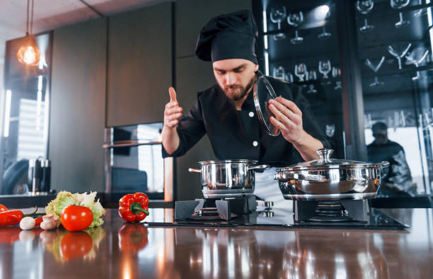 istock Professional young chef cook in uniform have a busy day on the kitchen 1324870818