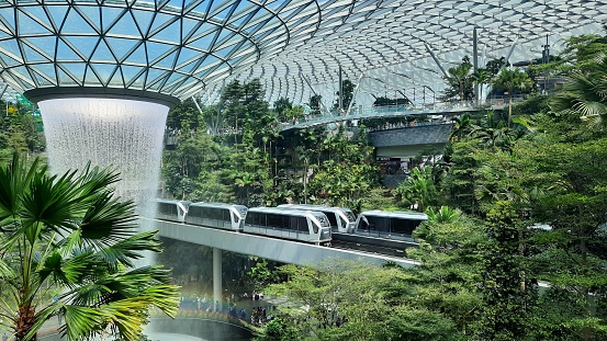 Sky trains passing roof waterfall at \