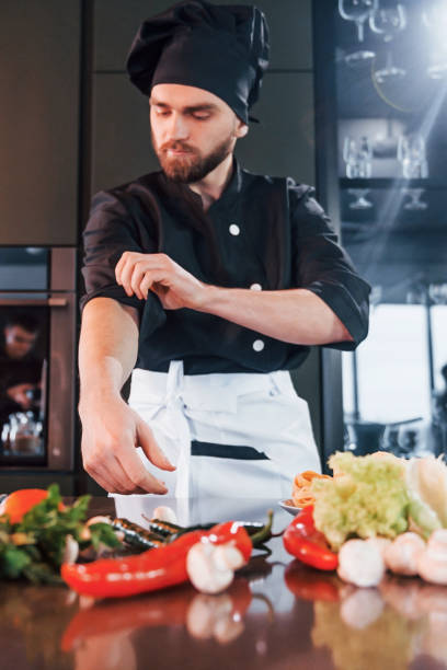 istock Professional young chef cook in uniform have a busy day on the kitchen 1324870916