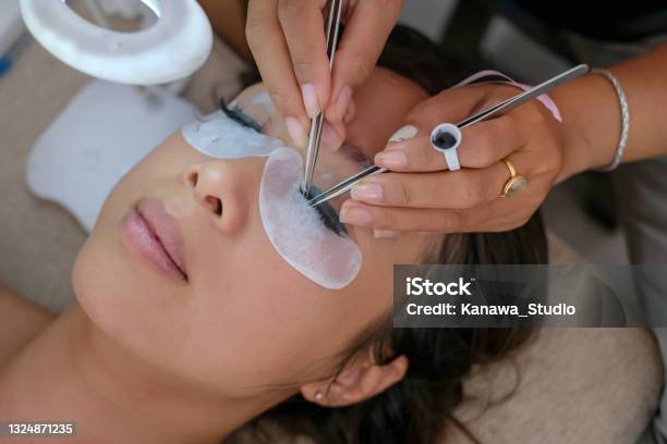 Beautiful Woman Getting Home Service Eyelash Extension Stock Photo - Download Image Now