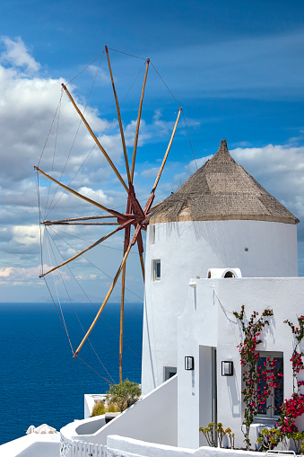 Classical view of an old windmill in Oia village on Santorini island, Greece.