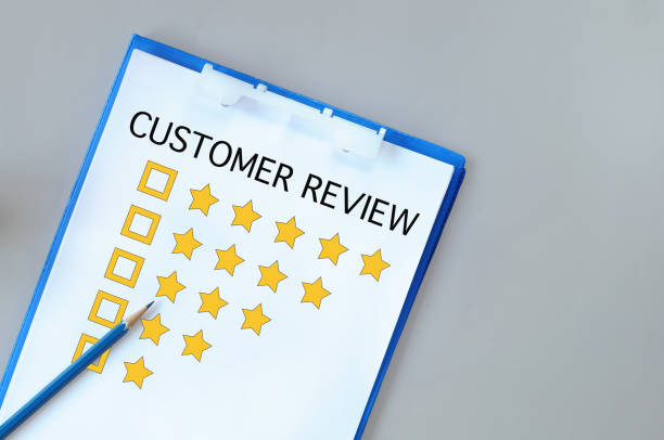 istock Customer review with check box on notepad with paper and pencil on grey background 1324871994