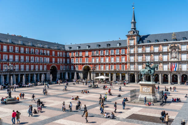 Plaza Mayor Square in Madrid. High Angle View Madrid, Spain - April, 18 2021: Scenic of Plaza Mayor Square in Madrid. View during restrctions for coronavirus covid-19 pandemic. Sunny day with blue sky habsburg dynasty stock pictures, royalty-free photos & images