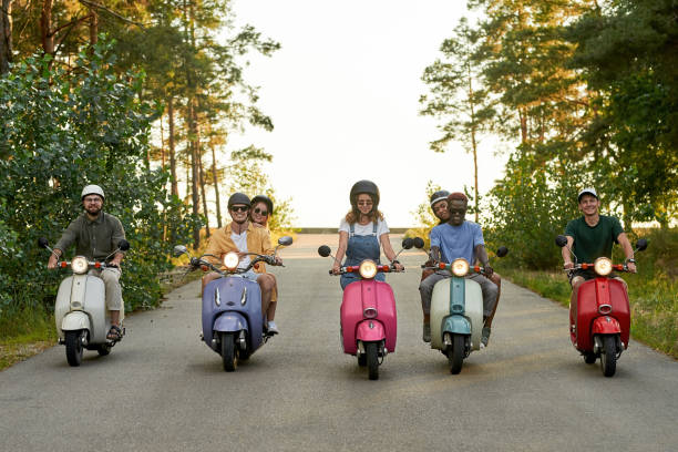 istock Happy young multiracial company riding colorful scooters 1324872200