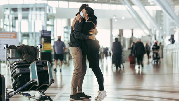 istock Couple meeting at airport arrival gate 1324872543