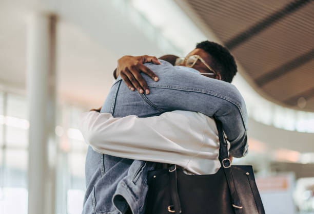 istock Couple meeting at airport arrival gate 1324872561