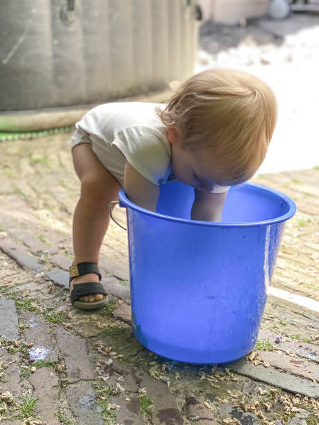 istock Baby girl playing with water 1324873716