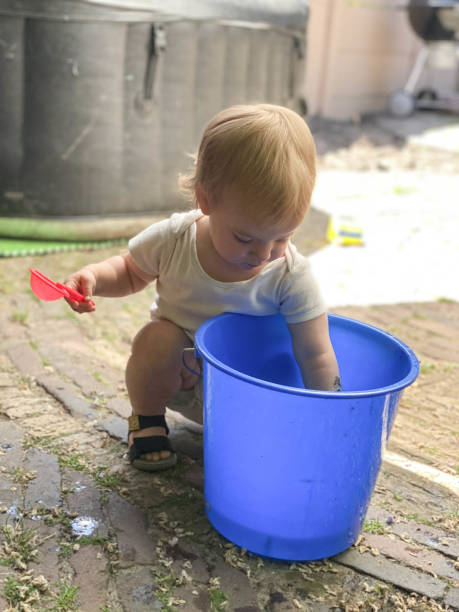istock Baby girl playing with water 1324874016
