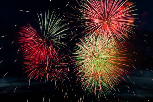 istock Bright colored fireworks on black background. Celebration and holidays concept. New Year, Independence Day, July 4 Festival. Bright explosions of lights in the sky. 1324875839
