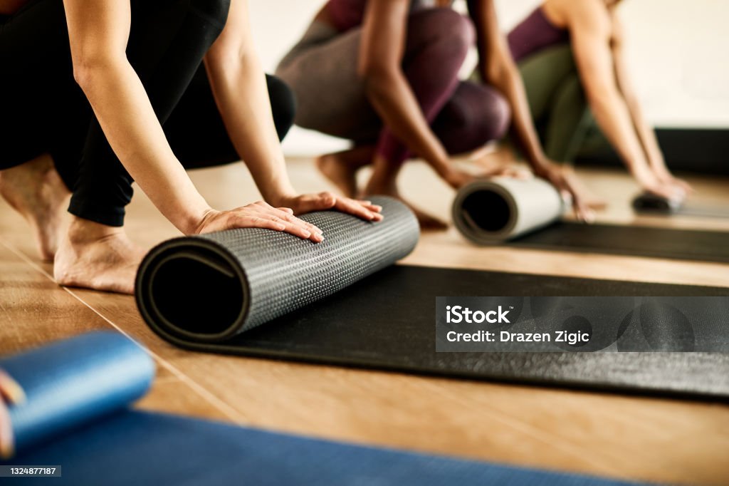 tieners Algemeen daarna Closeup Of Athletic Woman Rolling Up Her Exercise Mat After Practicing At  Health Club Stock Photo - Download Image Now - iStock