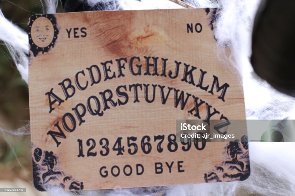 Ouija board in spooky setting Ouija board in spooky setting. Alphabet Stock Photo