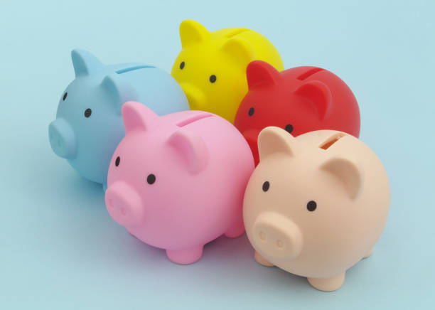 istock Many colorful piggy banks on blue background. 1324883949