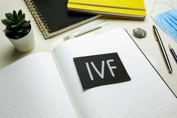 IVF (In Vitro Fertilization) written on open notebook stock photo