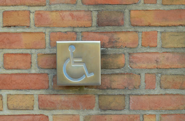 istock Push button for handicap door opener set against brick wall. 1324887986