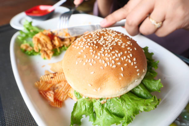 istock half eaten beef burger on table close up 1324888135
