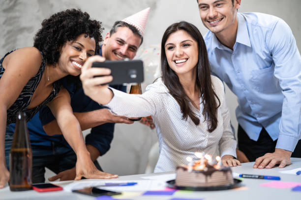 istock Business colleagues taking a selfie during birthday party at work 1324889634