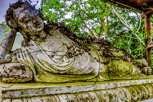 Reclining Buddha has been lying down for a long time, so moss grows on his body